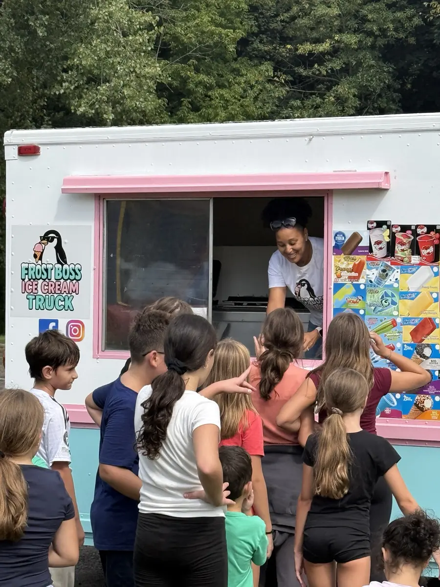Children lined up at the Frost Boss Ice Cream Truck service window